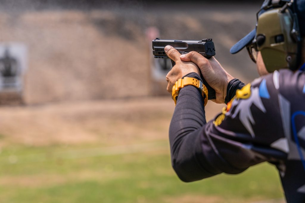 Man shooting a pistol at the shooting range